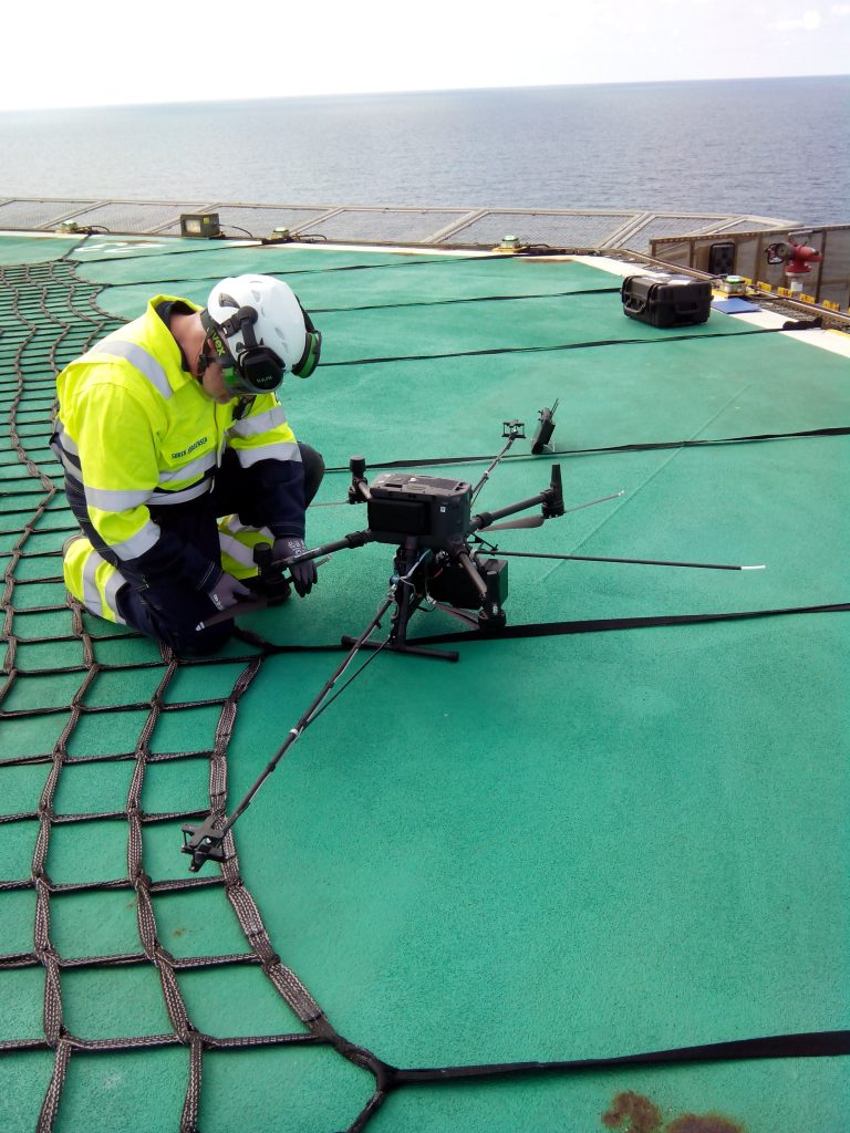 Crew with drone at offshore platform