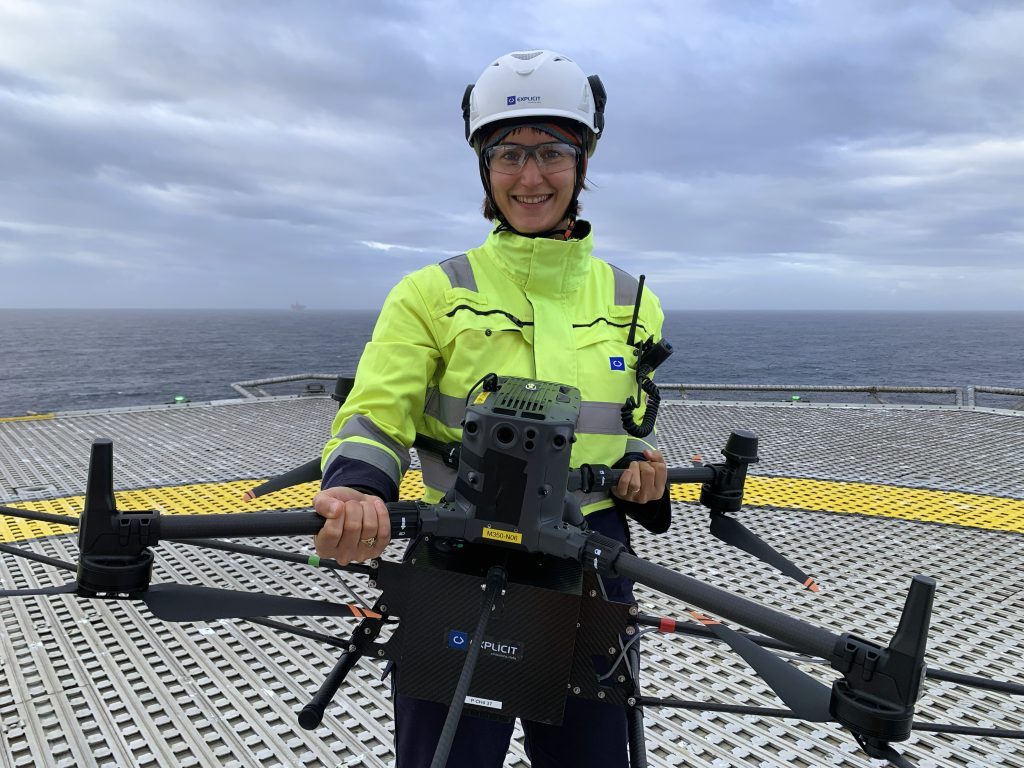 Explicit team member holding a drone on an offshore platform during a methane emissions survey