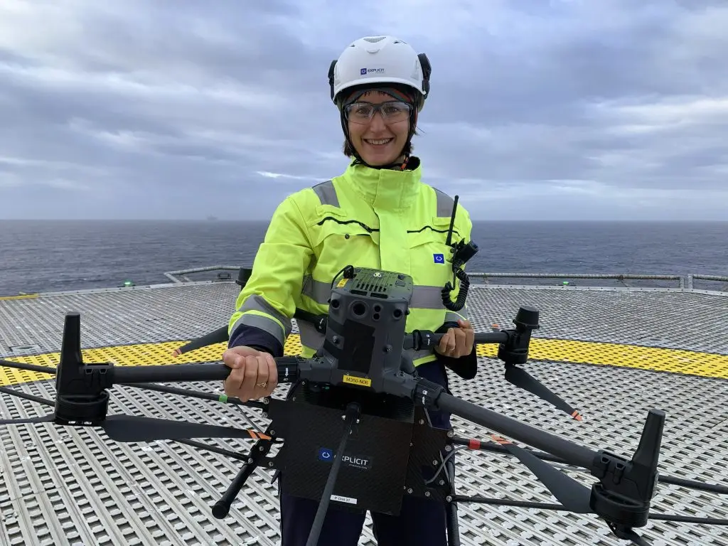 Explicit team member holding a drone on an offshore platform during a methane emissions survey